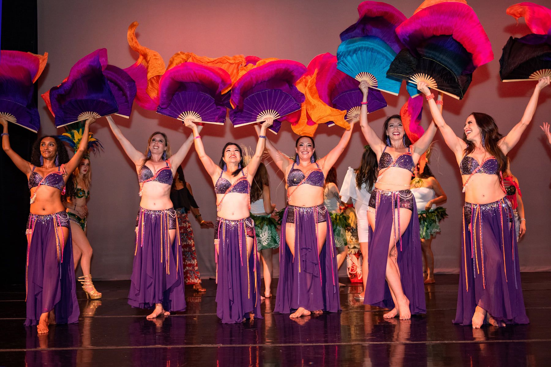 Student in Colorful World Dance Costumes Performing On Stage